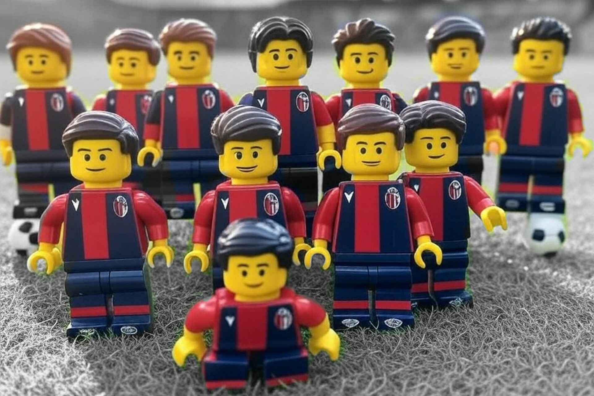 Minifigure LEGO in divisa del Bologna FC schierate su un campo da calcio, simbolo ironico della squadra di professionisti e partner affidabili.